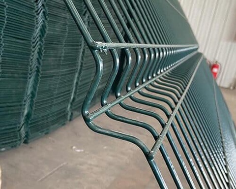 Green 3D curved fence panels ready for project installation