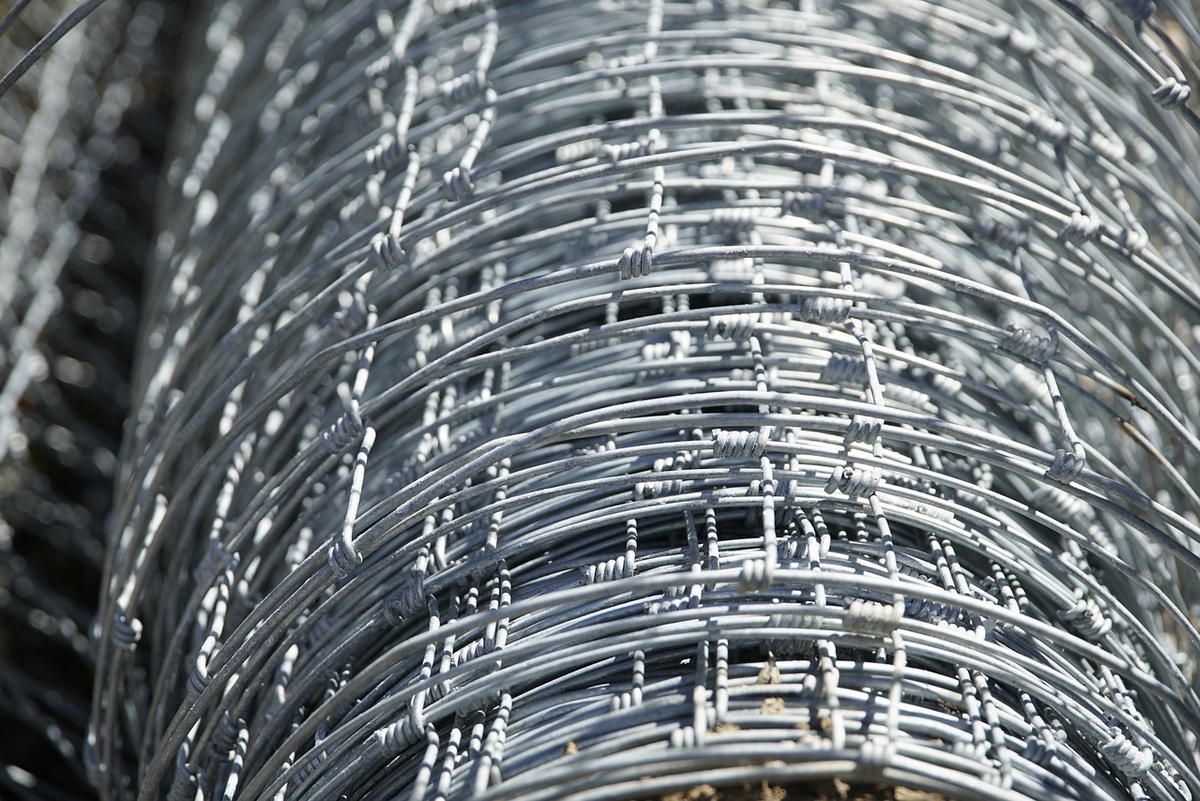 Close-up of zinc-coated wire roll showing galvanized steel surface